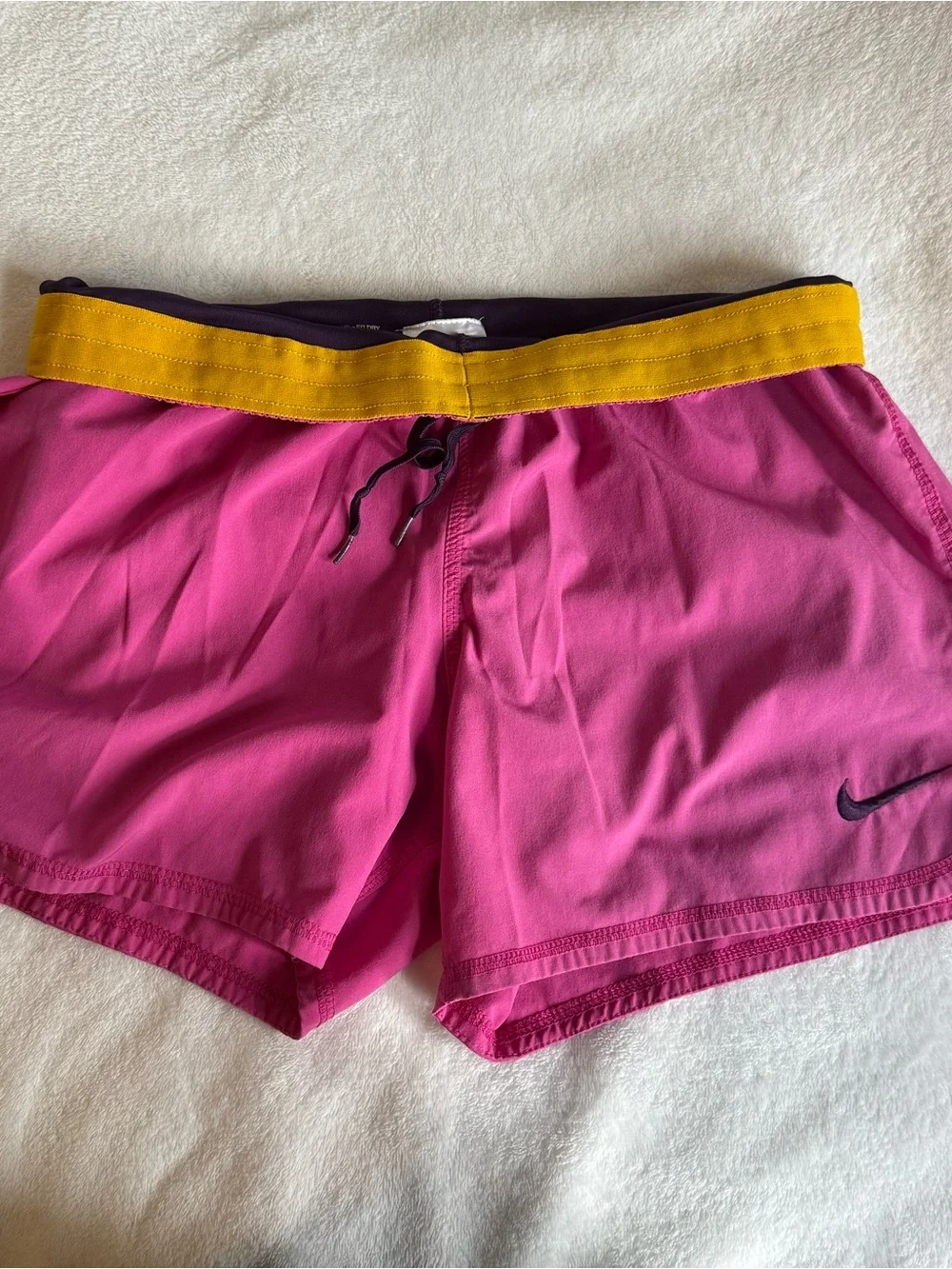 pink Nike track shorts